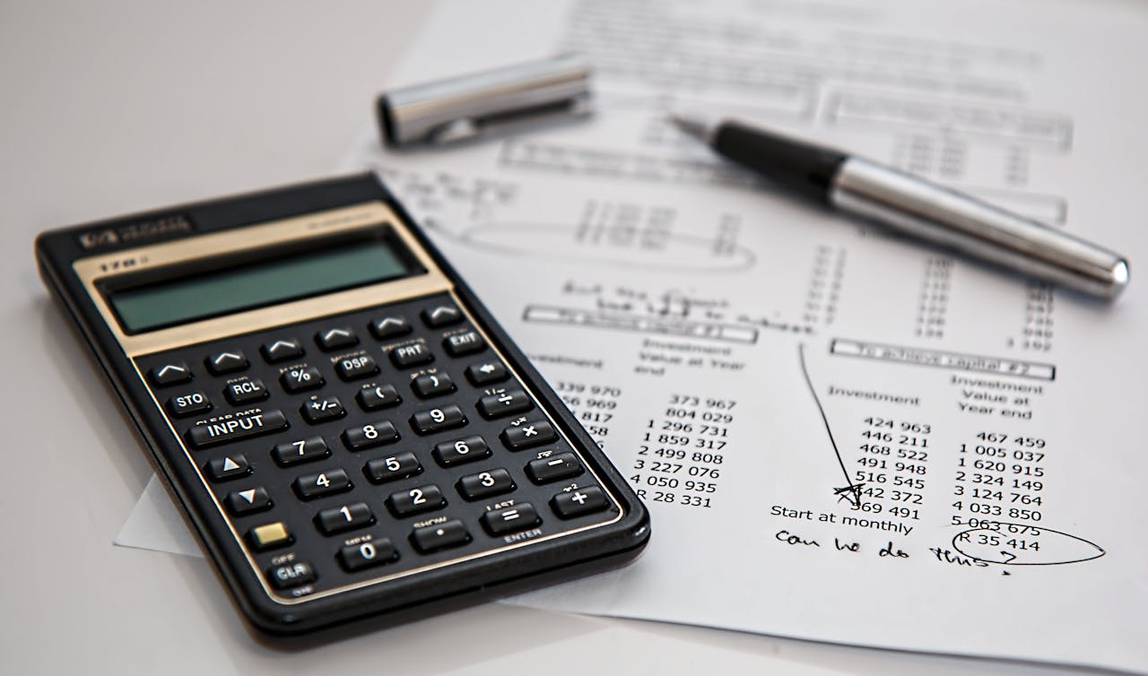 services-06 Close-up of financial documents with calculator and pen, ideal for business management themes.